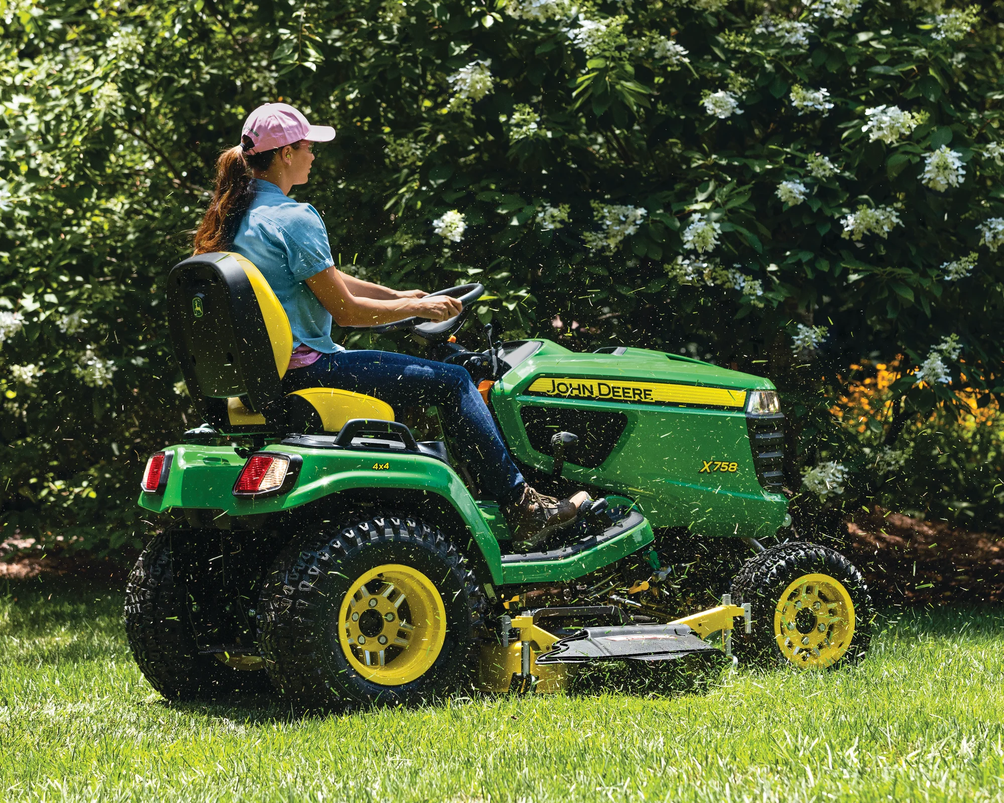 John Deere Signature X700 Series Garden Tractor X758 Side View Left Woman Cutting Grass product image