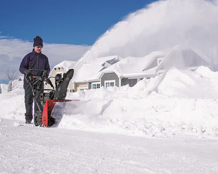Toro SnowMaster Snow Blower 724 QXE 36002 Toro Snowmaster Series Two Stage Snow Blower 36002 Front View Left In Use Sidewalk product image